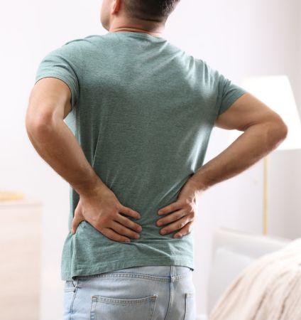 A Person Holding His Back in Pain 